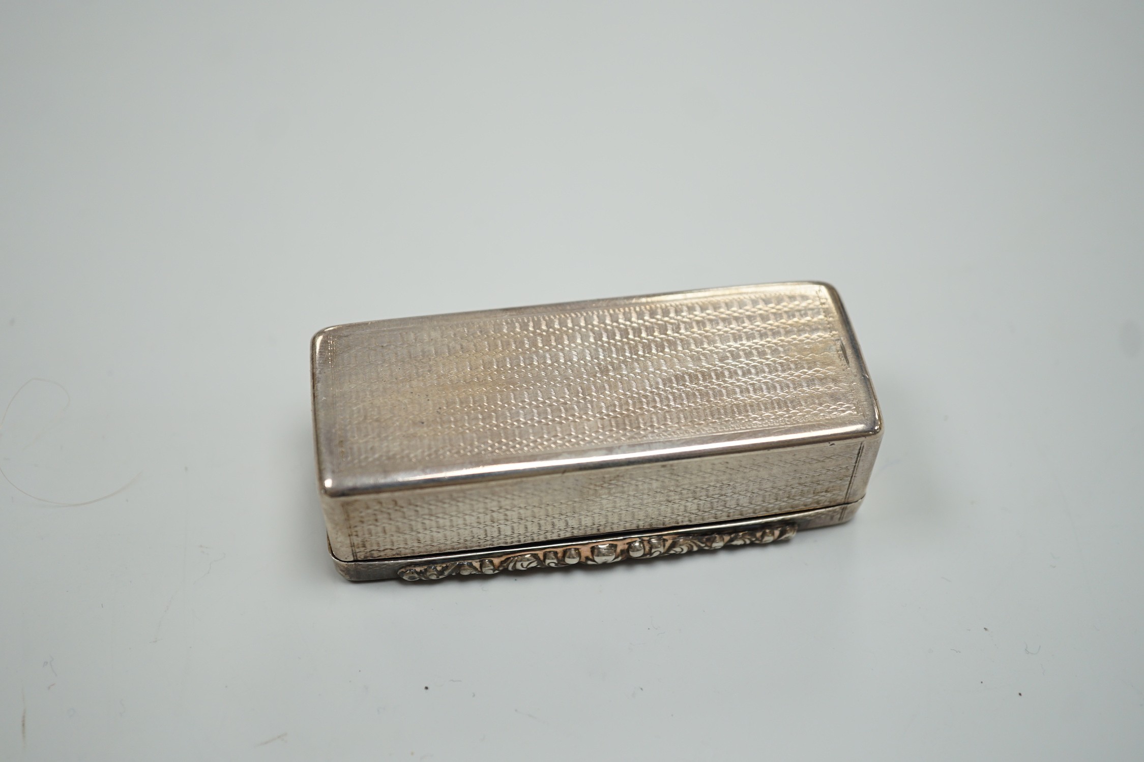 An early Victorian engine turned silver rectangular snuff box, Edward Smith, Birmingham, 1843, 77mm, with engraved initials.